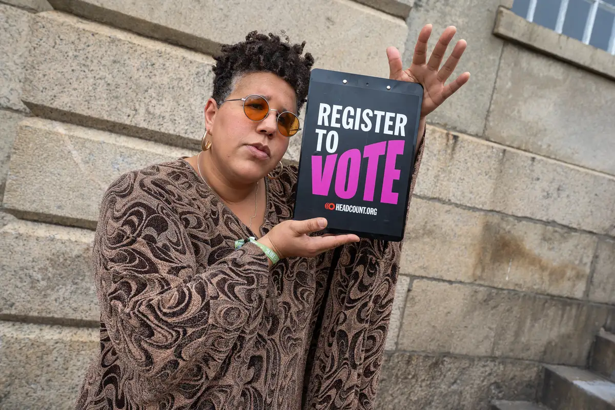 Brittany Howard at Newport Folk with a Register to Vote clipboard